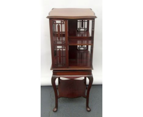 An unusual, mahogany, small, revolving bookcase, the stand with low shelf and carved cabriole legs, height 95cm.