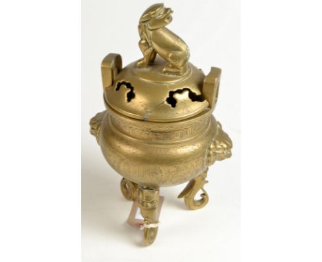 A Chinese polished and engraved bronze censor, the lid with a cast dog finial, standing on three mask cast and scroll feet, h