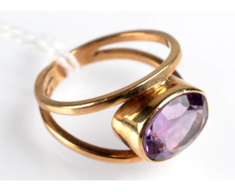 A 9ct. gold split shank ring set an oval, faceted amethyst. Condition Report: Size K