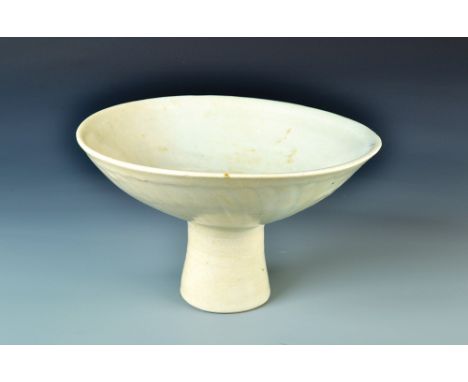 A Bernard Leach celadon porcelain stem bowl. the exterior with cut fluting. Impressed pottery and personal seals. Diameter 22