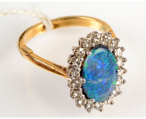 An oval opal doublet ring within 18 diamonds on patent Jacob Newman and Co expanding shank. Opal cracked.
