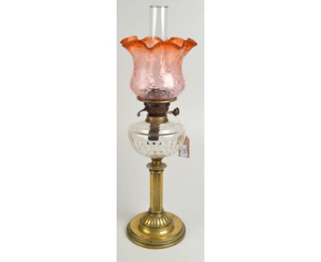A late Victorian or Edwardian oil lamp with pink glass shade, cut glass fount and brass column stand. 
