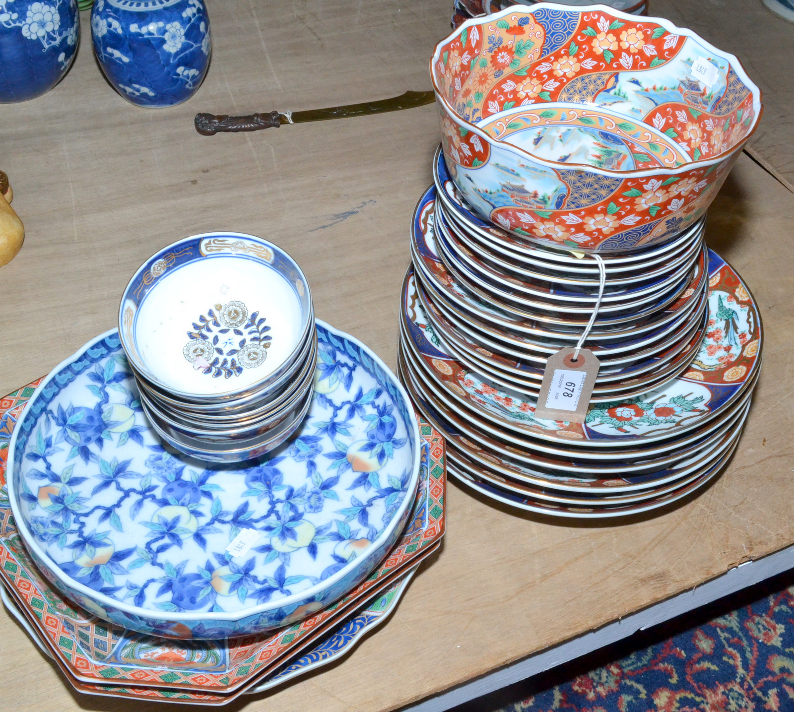 A large group of modern Japanese porcelain plates and bowls.