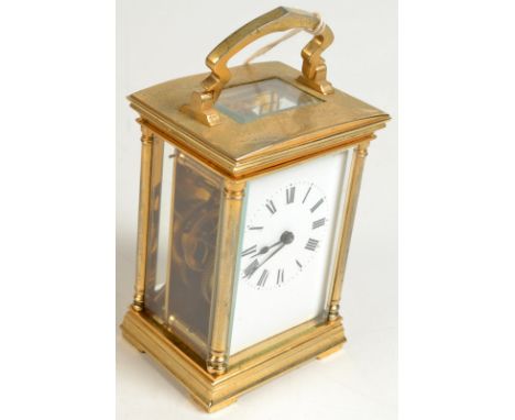 A brass carriage clock, height 11cm.  
