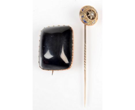 A gold stick pin, the pearl set finial with traces of blue enamel, together with a Victorian gold mounted jet brooch. 