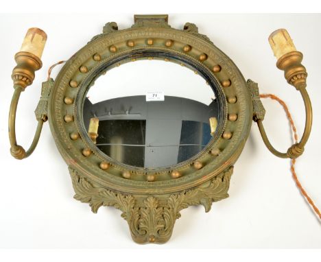 A circular gilt convex ball mirror with twin lamp sconces. 