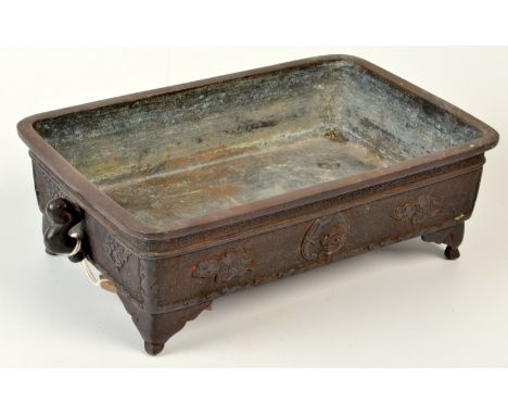 A Japanese early Meiji period two handled bronze bonsai planter of rectangular form, the sides decorated with a coiled dragon