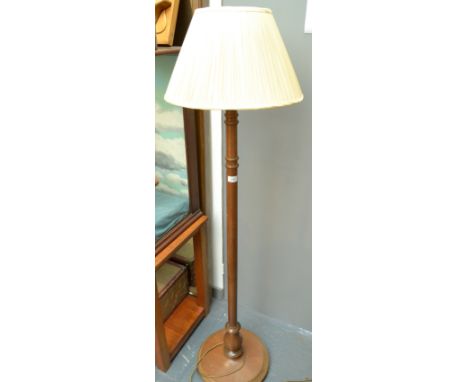 A turned mahogany standard lamp with shade.