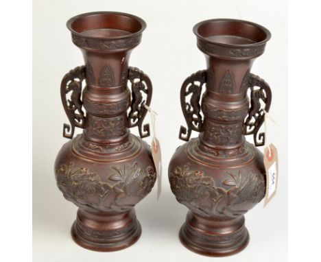 A pair of Japanese bronze vases, early 20th century decorated with birds on flowering branches, height 26cm. 