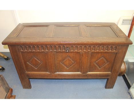 A late 17th Century joined oak chest, having a three panel lid opening to reveal a storage area and an open candlebox, three 