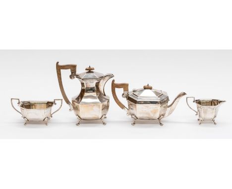 A George V silver matched four piece tea service comprising: teapot, hotwater jug, sugar bowl and milk jug, plain facet bodie