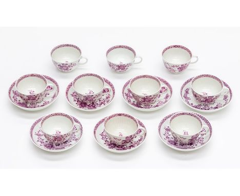 A set of ten 19th century German tea cups, and seven saucers, puce and gilt floral spray decoration on a ribbed body, undergl