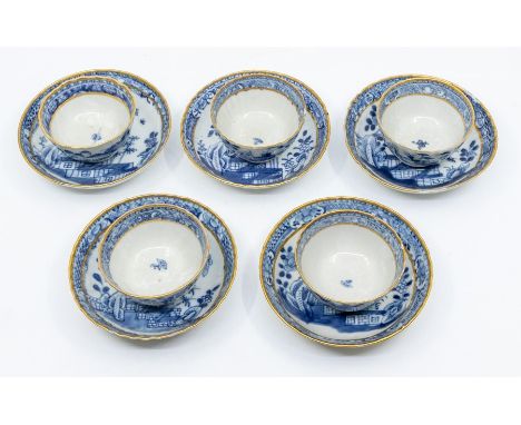 A set of five late 18th / early 19th Century tea bowls and saucers, scalloped gilt edges , the reserves decorated with prunus
