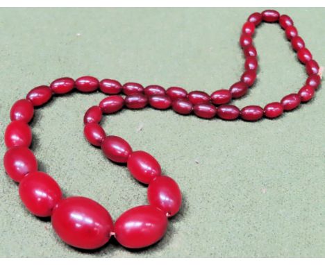 Large vintage strand of graduated Cherry Amber beads. Weight approx. 55.7g

Reasonable used condition 