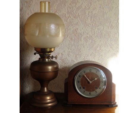 Copper and Brass oil lamp, plus oak cased mantle clock

Both in used condition, not tested for working, glass reservoir on oi