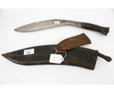 A vintage Nepalese Kukri knife and leather sheath. With carved hardwood grip and metal pommel overall length 47.5cm, together