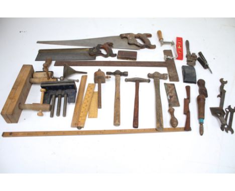 An assortment of vintage tools. Including saws, a ruler, clamps, a pen knife, etc.