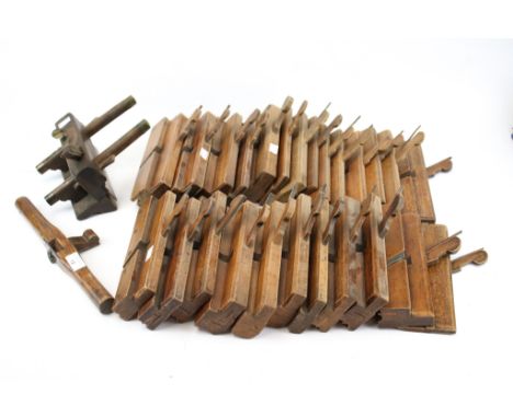 A collection of assorted vintage wooden carpentry tools. Including moulding planes and a plough plane stamped R. Routledge, B