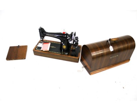 A vintage Singer sewing machine hand crank. S/n. EG 889244 with No. 201K instruction booklet and a 'claw foot' and a box of o