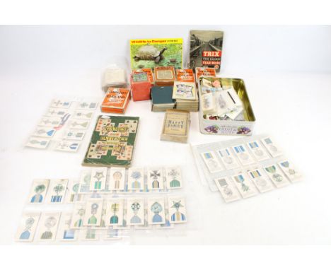 A collection of assorted vintage playing and trading cards. Including 'Happy Family', John Jaques 'Counties of England' ' Nat
