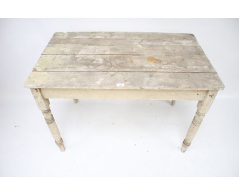 A vintage painted pine kitchen table. On turned tapering supports, L111cm x D69cm x H74cm