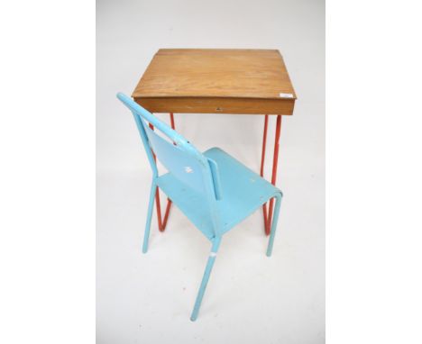 A vintage Tri-ang childs school desk and a chair. With lift up lid mounted on red steel tube supports L49cm x D43cm x H68cm, 