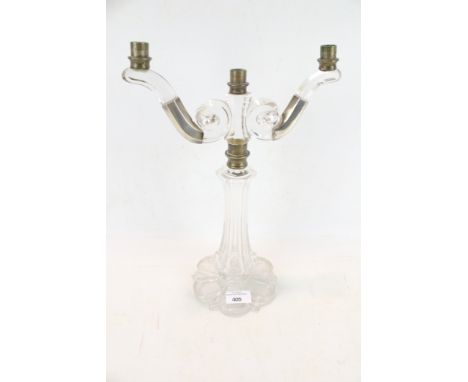 A glass candlestick in the style of 'Osler'. A three candlestick with a faceted column, two branches with scroll end, H36cm