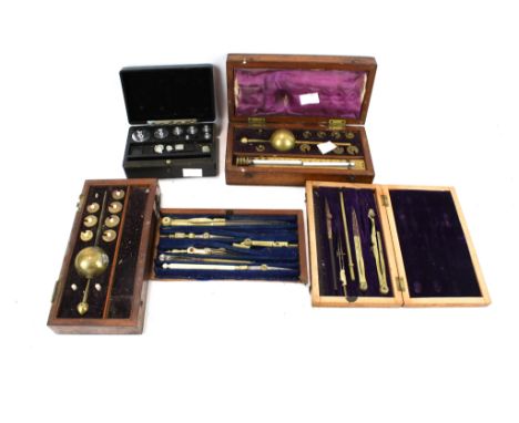 A collection of scientific instruments. Including two hydrometers, a set of weights, measurement tools, etc. 