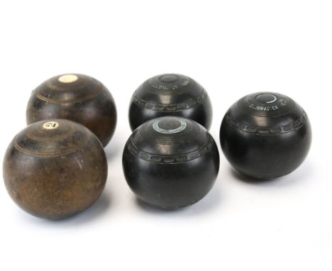 A collection of five vintage lawn bowls. Including a pair of wooden bowls and a set of three Almark Clubmaster 3 medium bowls