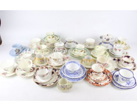 A collection of 19th century and later cups and saucers and trios. Including examples by Royal Doulton, Queen Staffordshire, 
