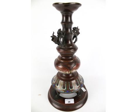 An early 20th century Japanese bronze candlestick with champleve enamel lotus decoration. H40cm