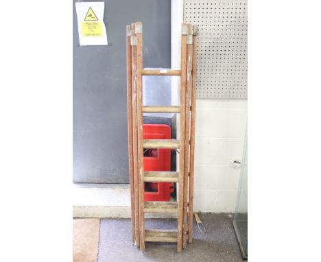 A three section wooden ladder. H350cm (approx)