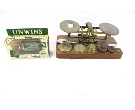 A vintage set of scales, a LLedo diecast model and a silver spoon. The diecast of a 'Unwins Wine Merchants' vehicle, the spoo