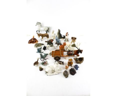 A collection of 20th century ceramic figures of animals. Including a Beswick horse, seals and a fox made in USSR, dogs, birds