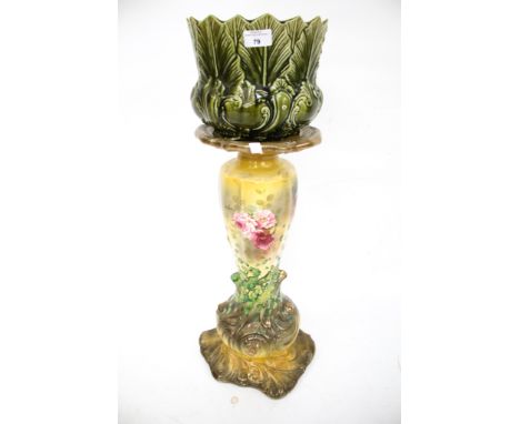 A 20th century ceramic jardiniere and stand. The majolica planter in the 'New Leaf' pattern, the stand decorated with roses o