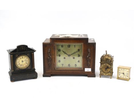 An oak cased mantle clock plus three others. Including a 1930s German H.A.C. oak cased striking mantle clock with a square di