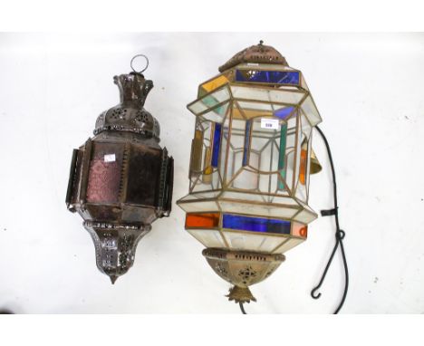 Two vintage lanterns. Both with pierced metal frames and coloured glass panels, largest H70cm