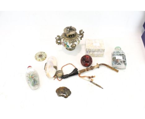 A small collection of Chinese and Oriental items. To include, a metal mounted censer; a hardstone round disc; a small carved 