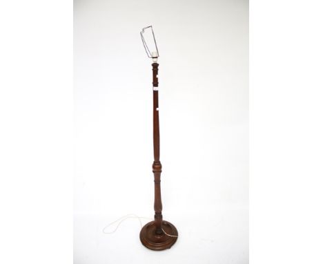 A vintage stained wooden floor lamp. The turned stand raised on a circular base with bun feet, H145cm (excluding fitting)