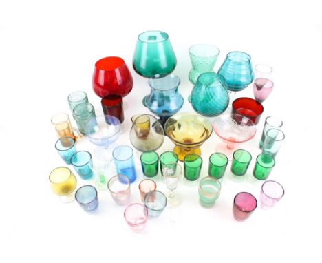 An assortment of vintage and later coloured glassware. Including beakers, wine glasses, spirit glasses, cocktail glasses, vas