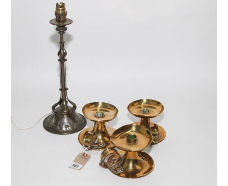 three arts and crafts brass chamber candle sticks, bases apprx 13cm in diameter and an arts and crafts brass and beaten pewte