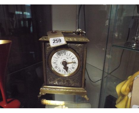 19th century French brass carriage/alarm clock stamped to the back Grand Prix De L'Horlogerie 1878, with white enamel dial, r