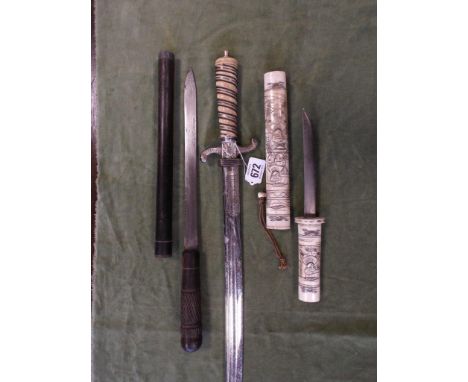 Japanese carved bone dagger together with a ceremonial short sword and a small stick dagger 