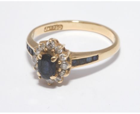 18ct gold sapphire and diamond cluster ring set with calibre sapphires to the shoulders, ring size approx M