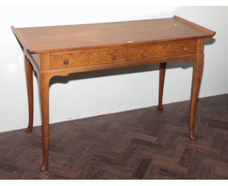 Whytock and Reid pale mahogany side table with turned up ends and fitted 2 drawers standing on cabriole style legs and paw fe