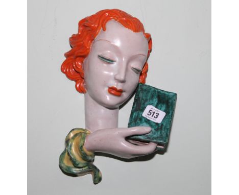 Goldscheider terracotta wall mask of a young red headed female holding a book, original label to the reverse, 30cm long   Con