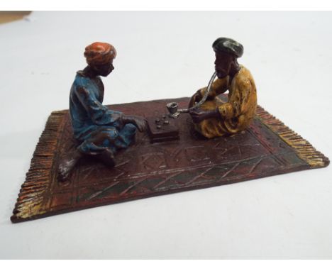 Cold painted bronze model of 2 Arab coffee drinkers sitting on a carpet, carpet 11cm x 7cm