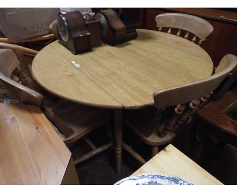 Light oak finished drop leaf dining table and four Windsor style farmhouse design chairs 