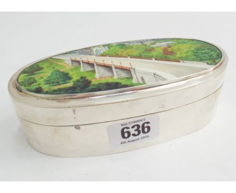 Late 19th century oval silver box with hinged lid and enamel decoration of a bridge scene, London 1891.  Makers mark EB.  14c