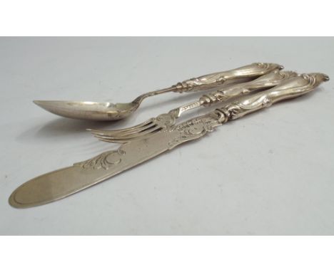 Mid 19th century silver three piece christening set comprising fork, knife and spoon, each with embossed handle Birmingham 18